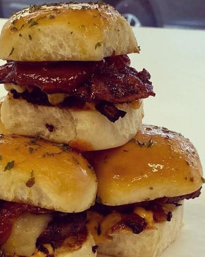 McKnight's signature bacon cheeseburger sliders stacked and ready to serve